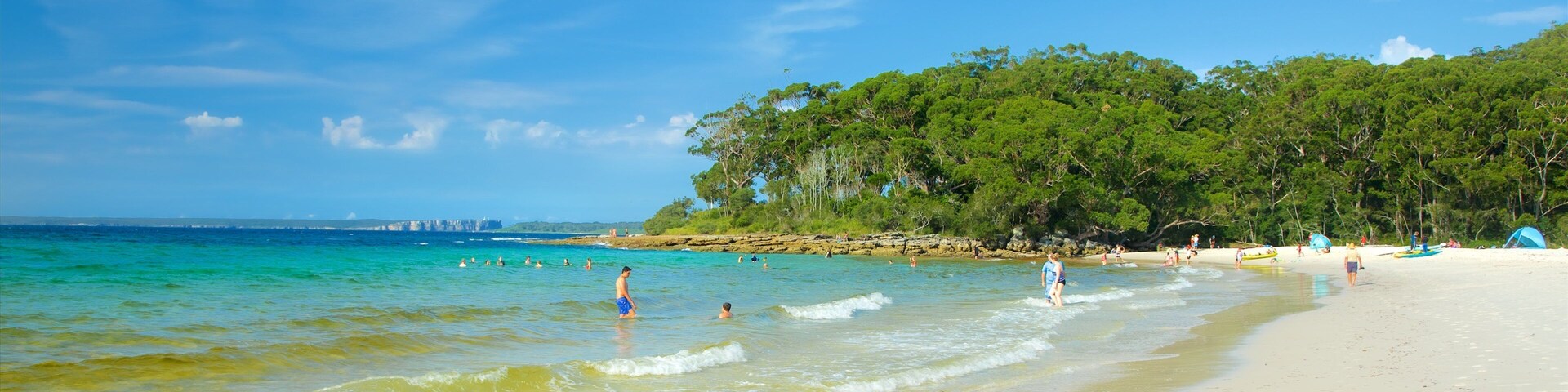 Booderee National Park featuring a sandy beach as well as a small group of people
