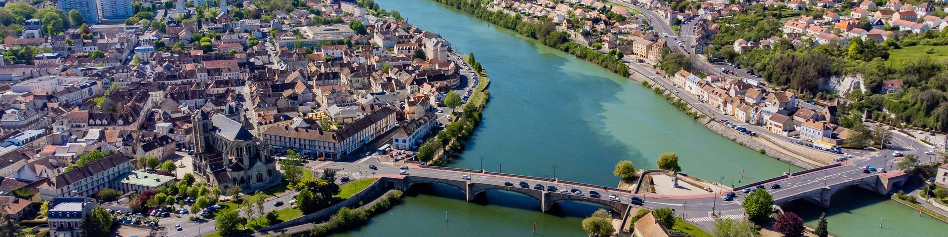 Aerial view of the confluence between the Seine and the Yonne showing different colors of water mixing in the town of Montereau Fault Yonne in Seine et Marne, France