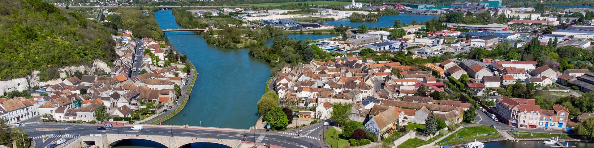 Aerial view of the confluence between the Seine and the Yonne showing different colors of water mixing in the town of Montereau Fault Yonne in Seine et Marne, France