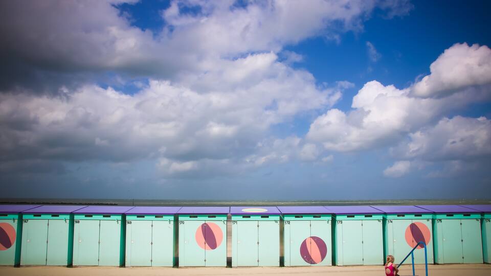 A row of numbered lockers with a child playing in the foreground.
