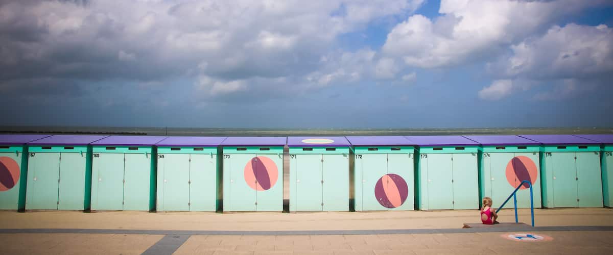 A row of numbered lockers with a child playing in the foreground.