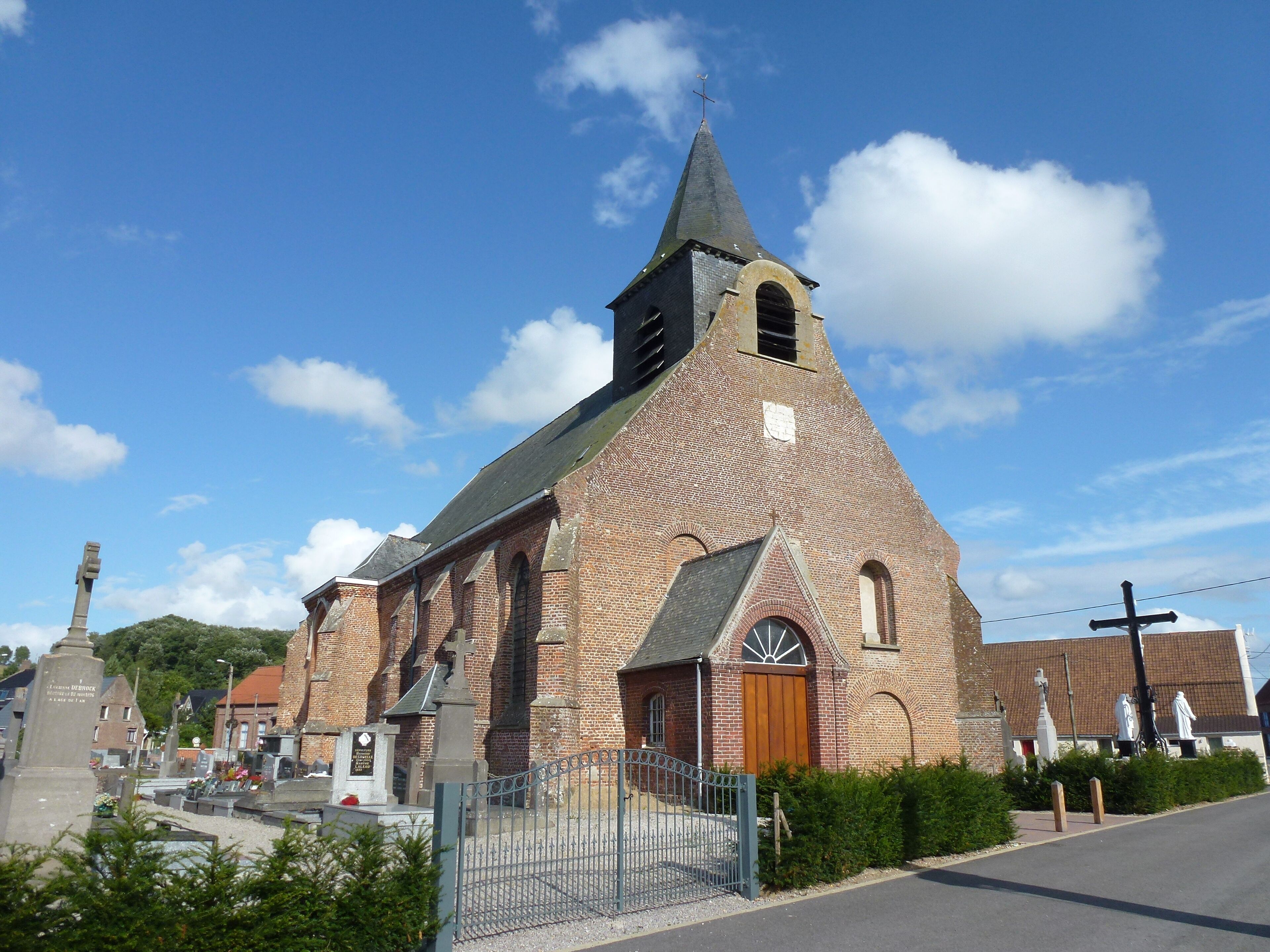 A church with a tall steeple and a brick facade.