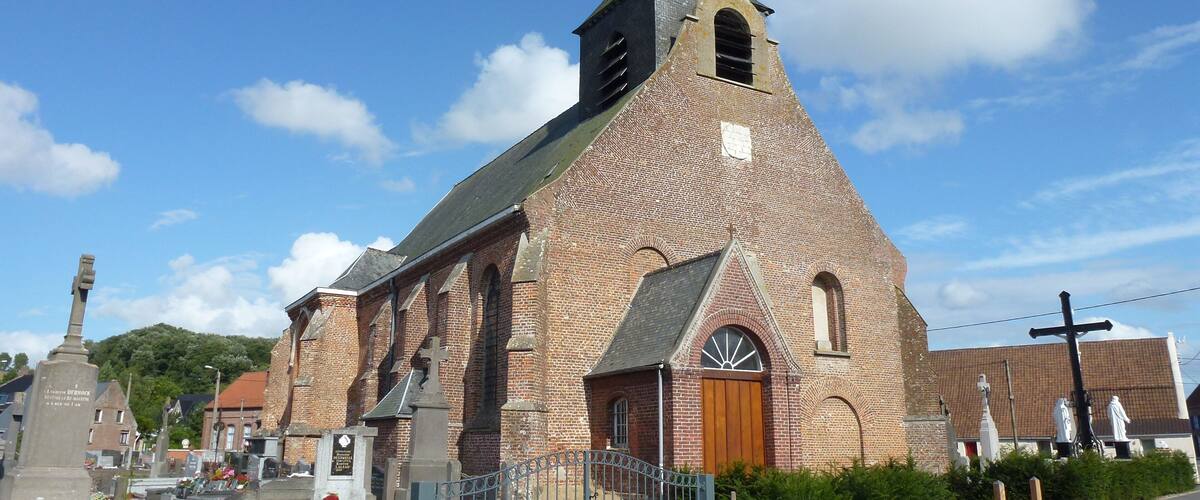 A church with a tall steeple and a brick facade.