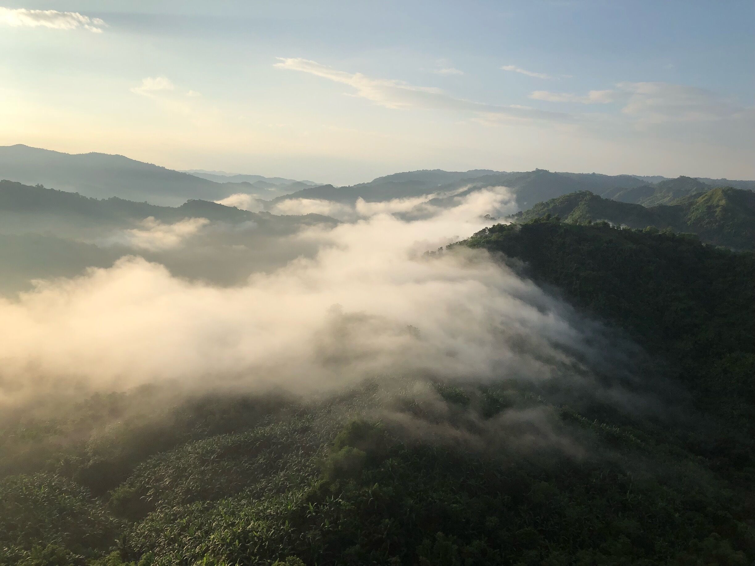 A mountainous landscape with dense fog covering the valleys.