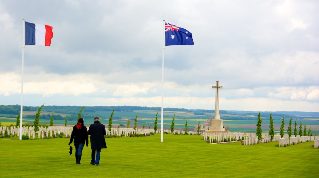 Villers-Bretonneux featuring a cemetery and a memorial as well as a couple