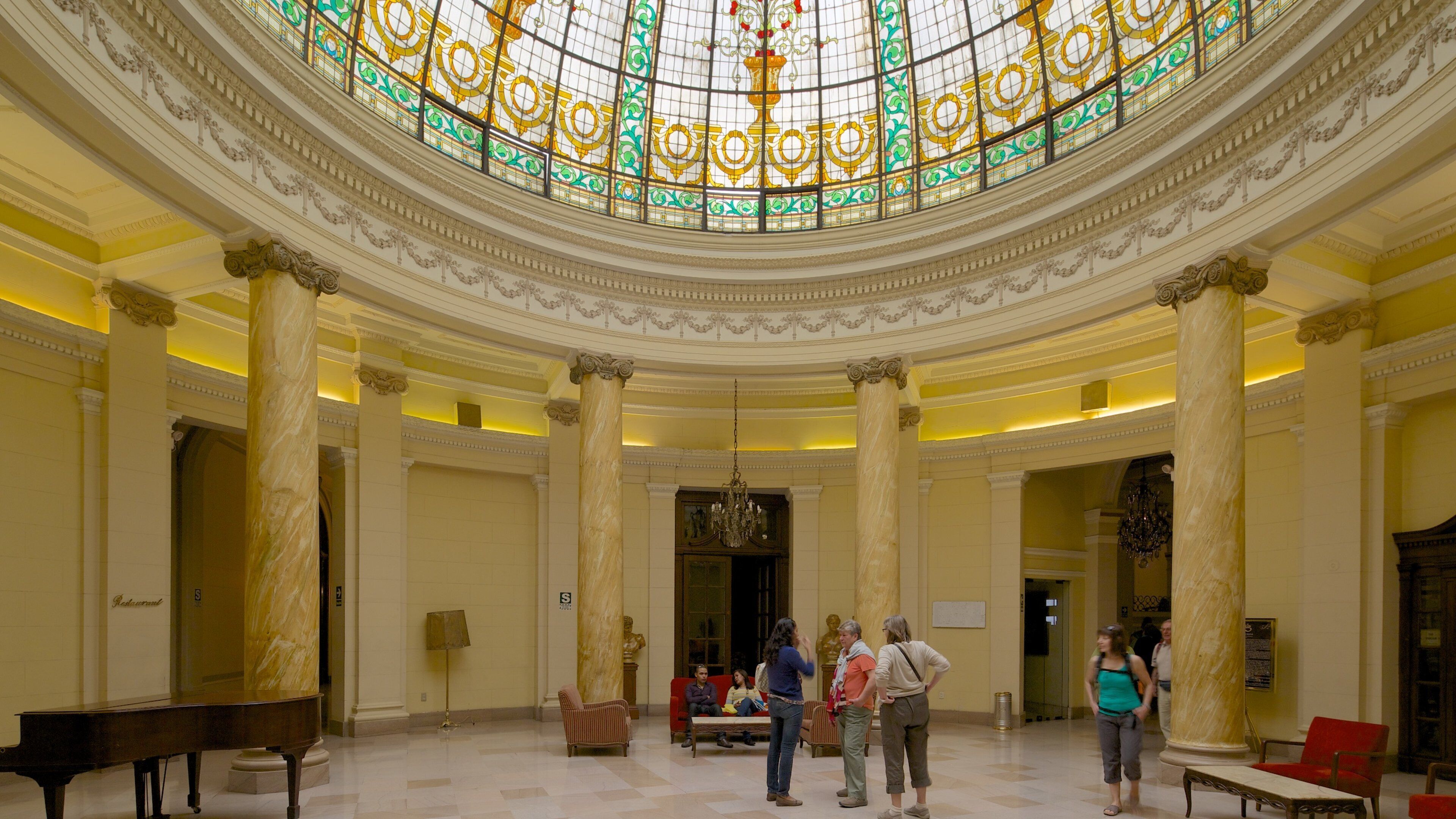 Plaza San Martin featuring interior views and heritage architecture as well as a large group of people