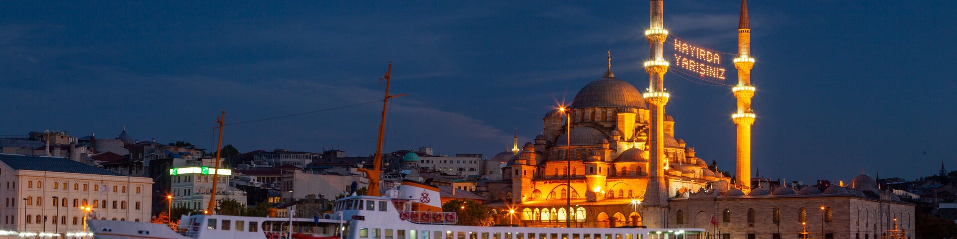 New Mosque showing a coastal town, a bay or harbor and heritage architecture