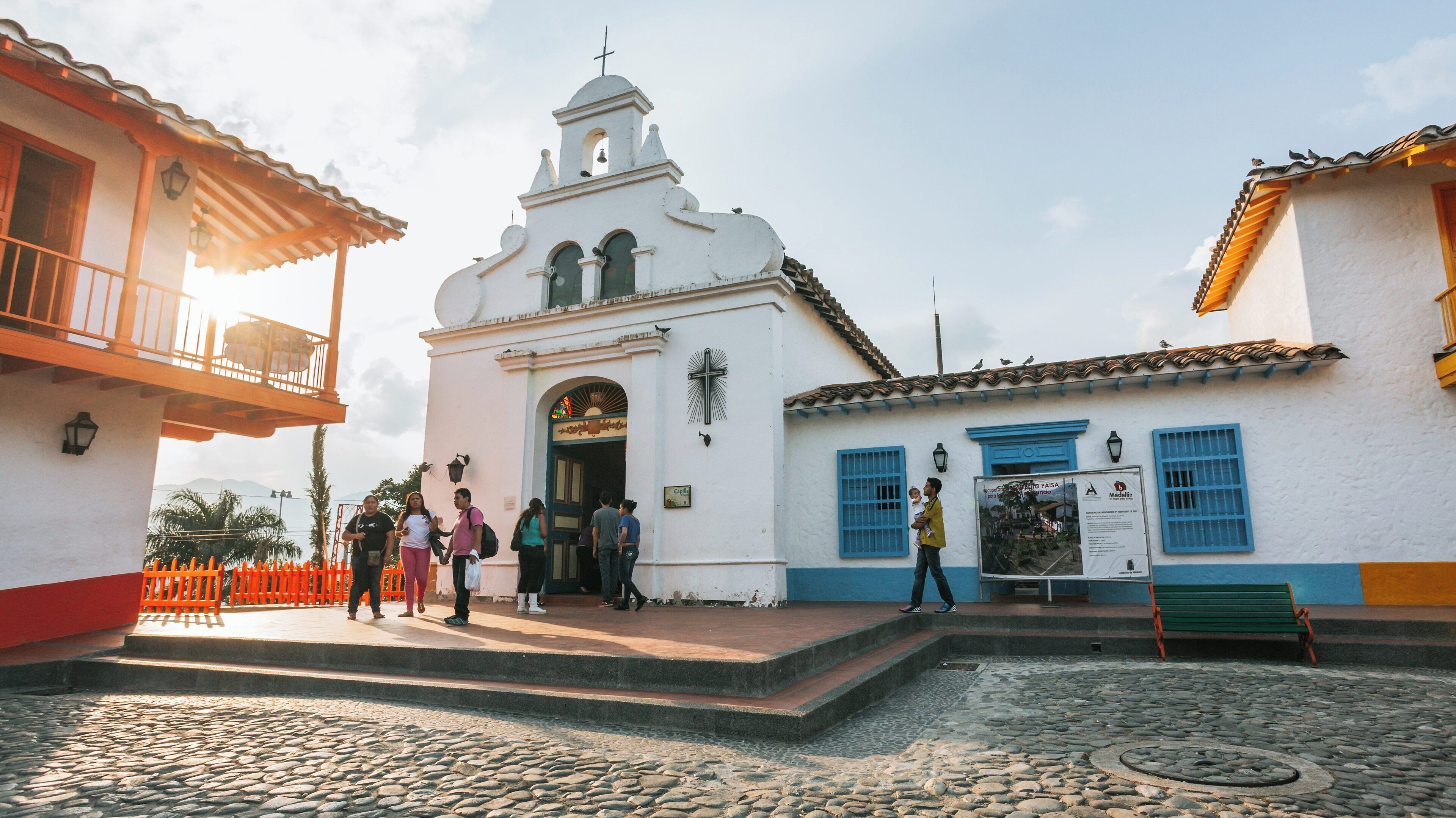 Exploring Pueblito Paisa in Medellin Antioquia Colombia at sunset with vibrant architecture and lively atmosphere