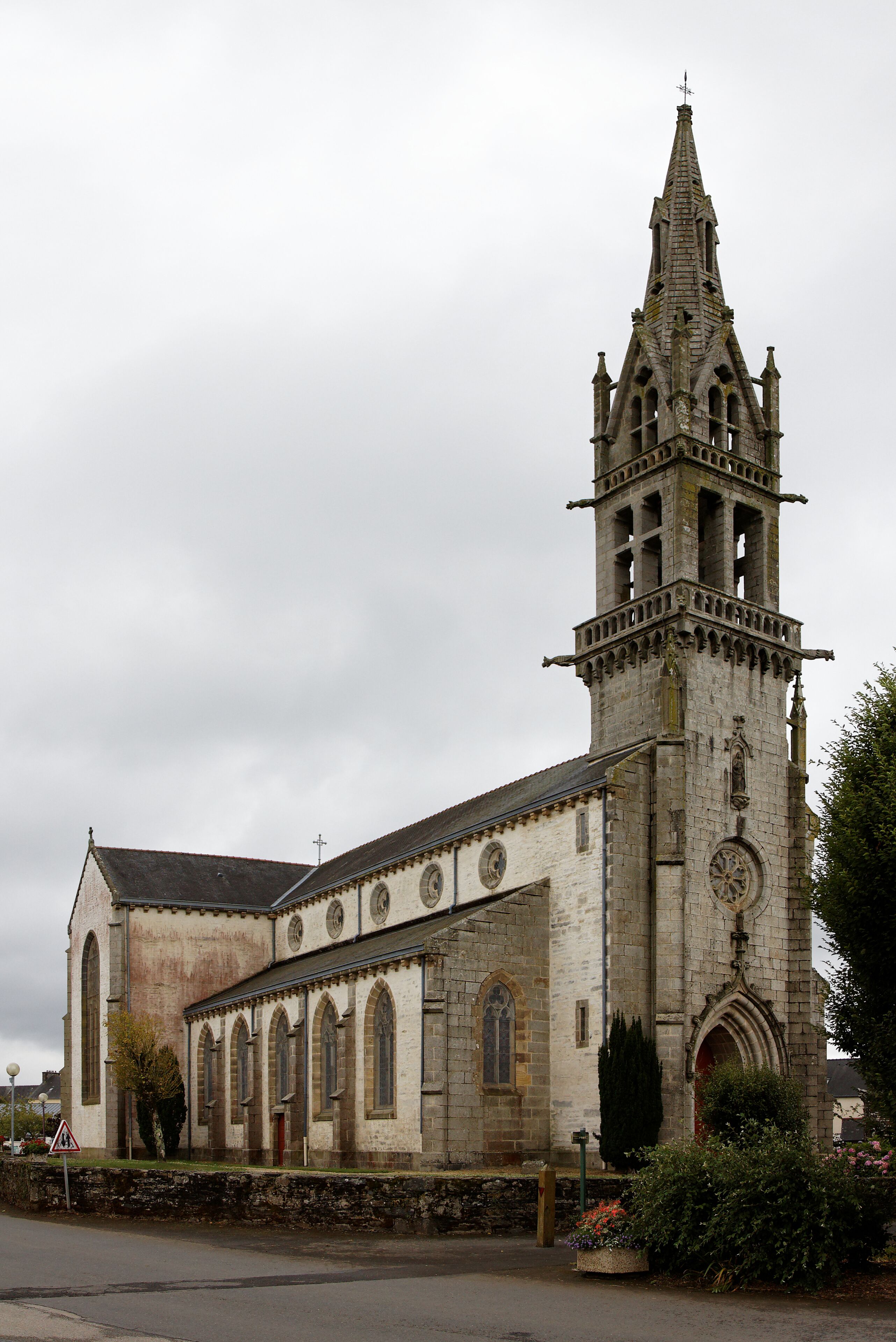 A historic church with a tall bell tower and arched windows.