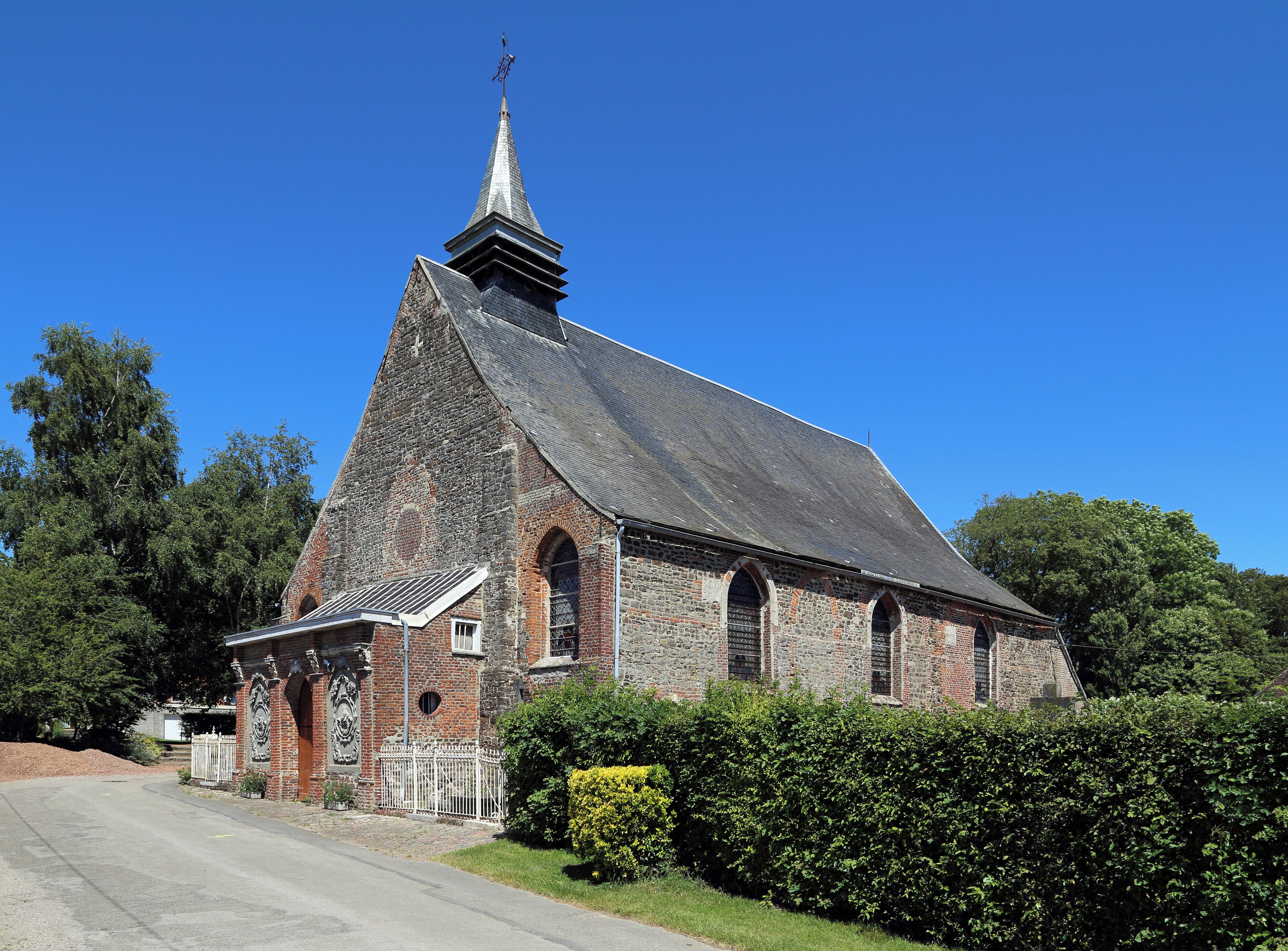 A historic church with a tall steeple and brick walls.