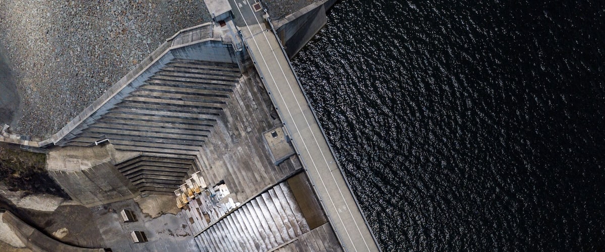 An aerial view of a dam with a spillway and a lock system.