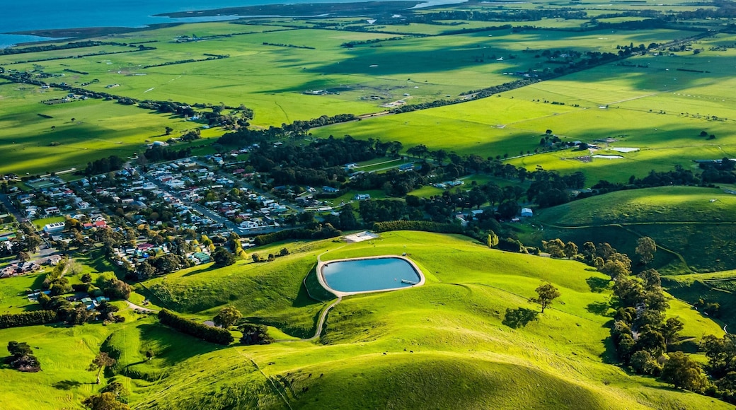 Aerial shot of a rural landscape featuring a lake and green fields. Toora, Victoria, Australia.