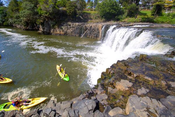 Haruru Falls featuring a river or creek, kayaking or canoeing and a cascade