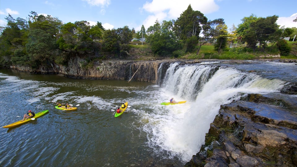 A waterfall with kayakers navigating the rapids.