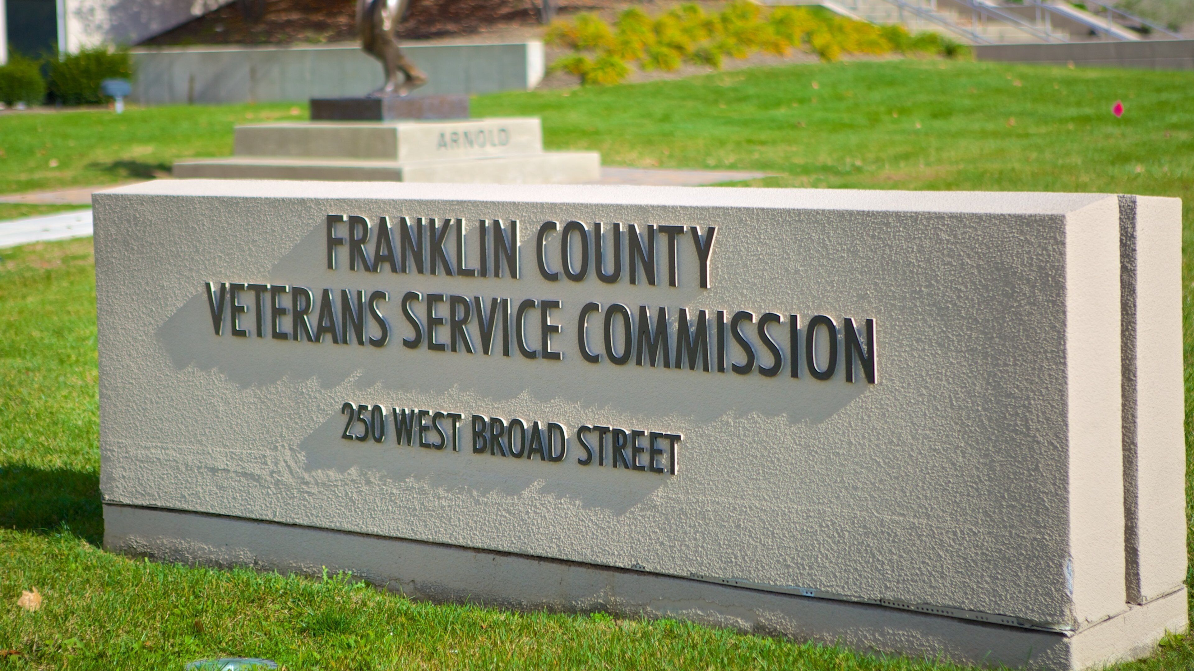 Veterans Memorial featuring a garden, a memorial and signage