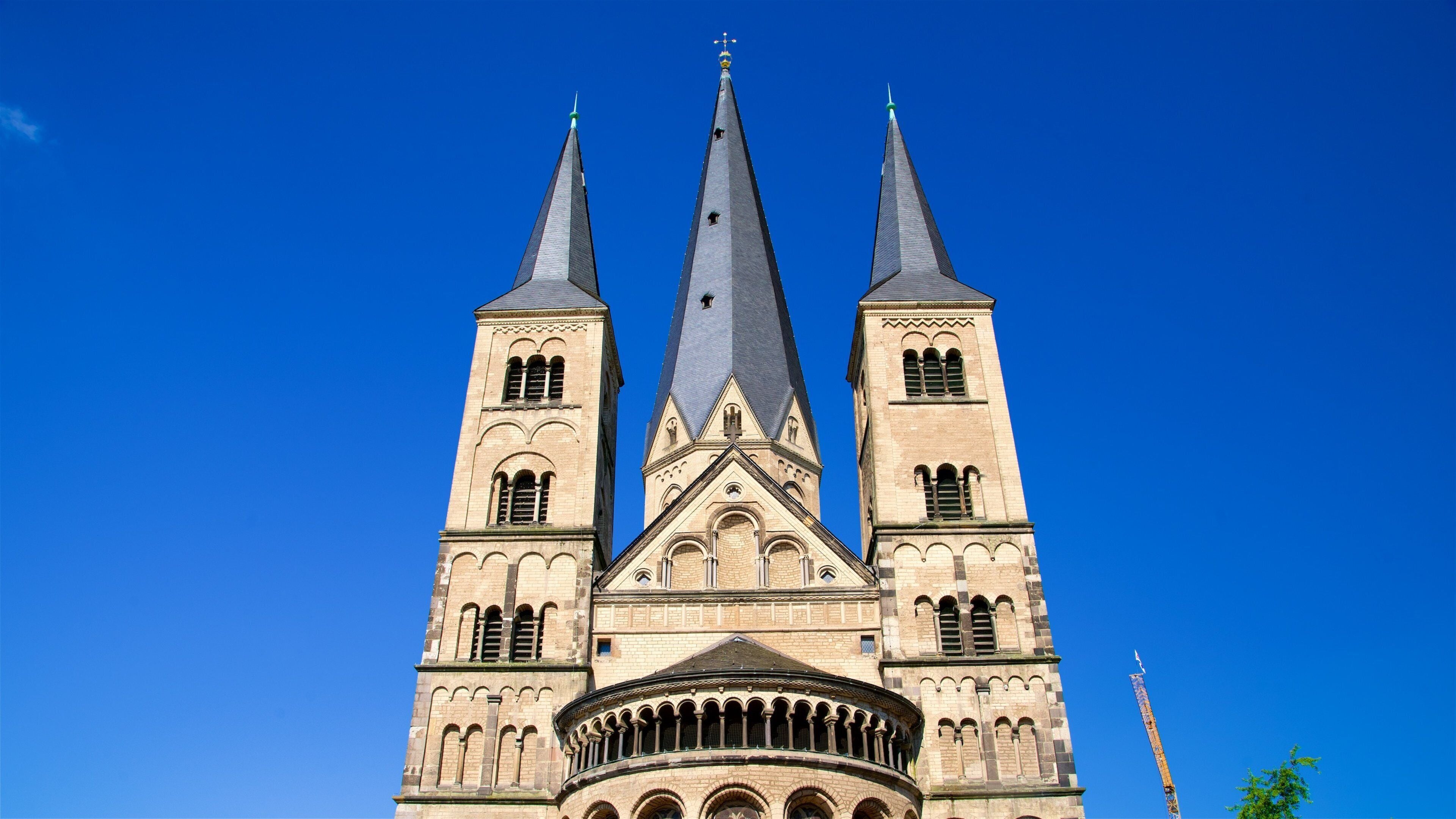 A large church with three spires and a circular balcony.