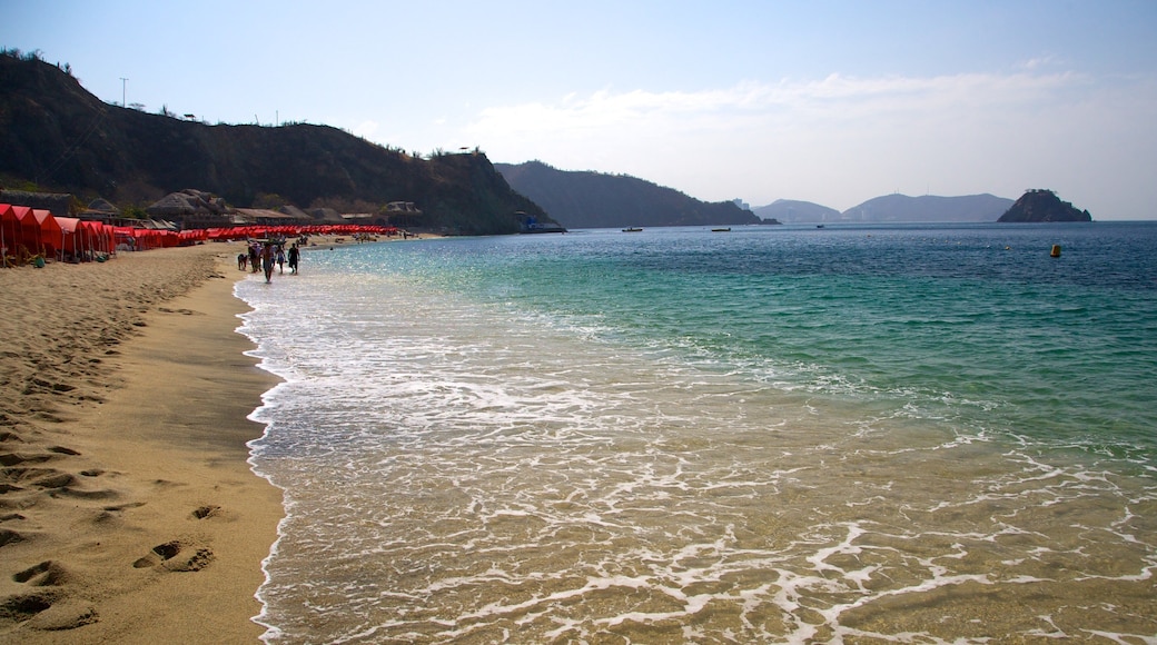 Blanca Beach showing a sandy beach and landscape views