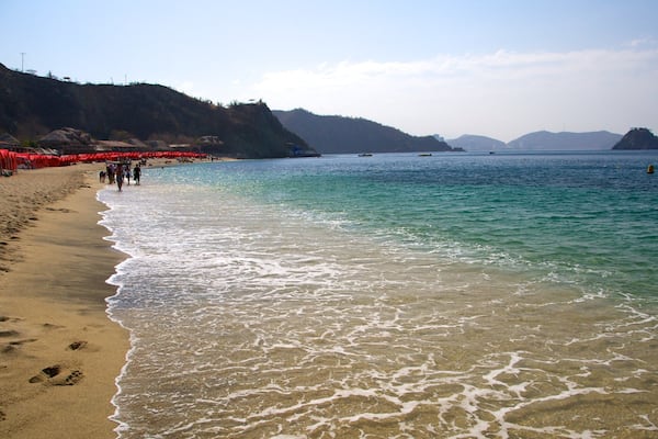 Blanca Beach showing a sandy beach and landscape views