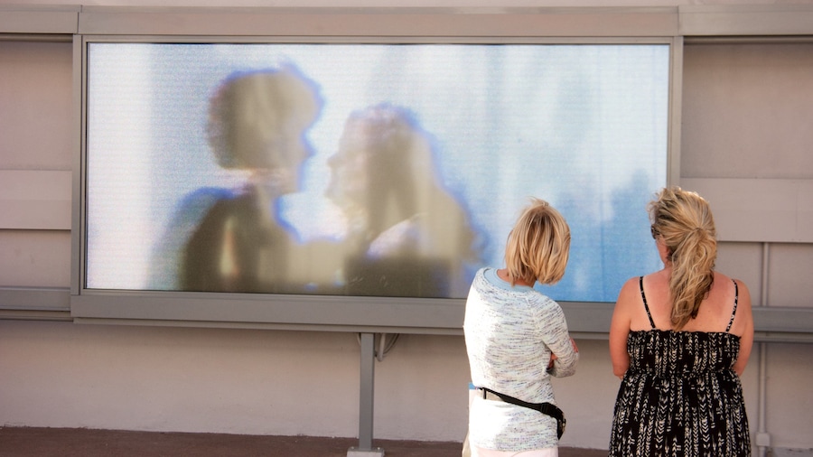 Bee Gees Way showing outdoor art as well as a small group of people