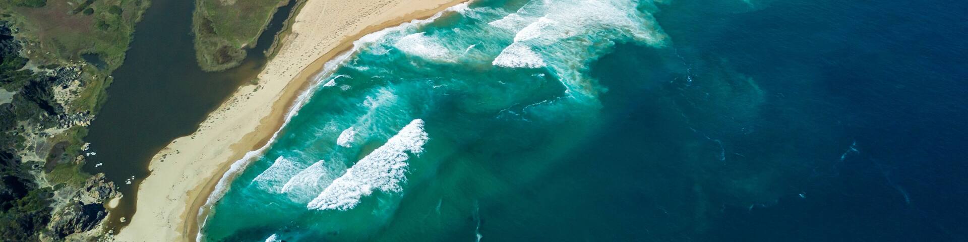 An aerial drone view over Tunquen Beach in Valparaiso region and close to Algarrobo, an awesome beach with a lot of wildlife because of it wetlands and turquoise waters, an idyllic travel destination