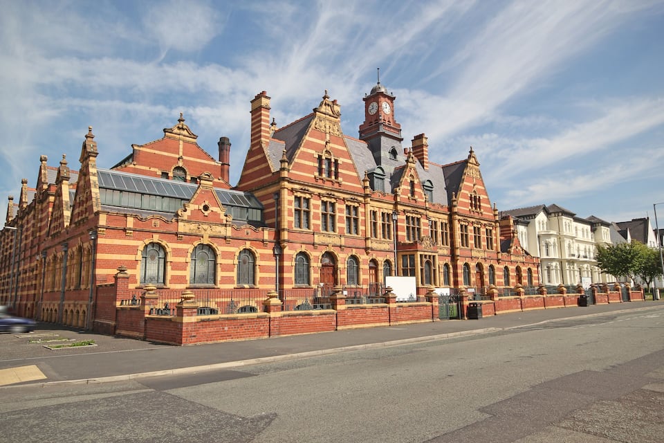 A historic building with a clock tower and red brick architecture.