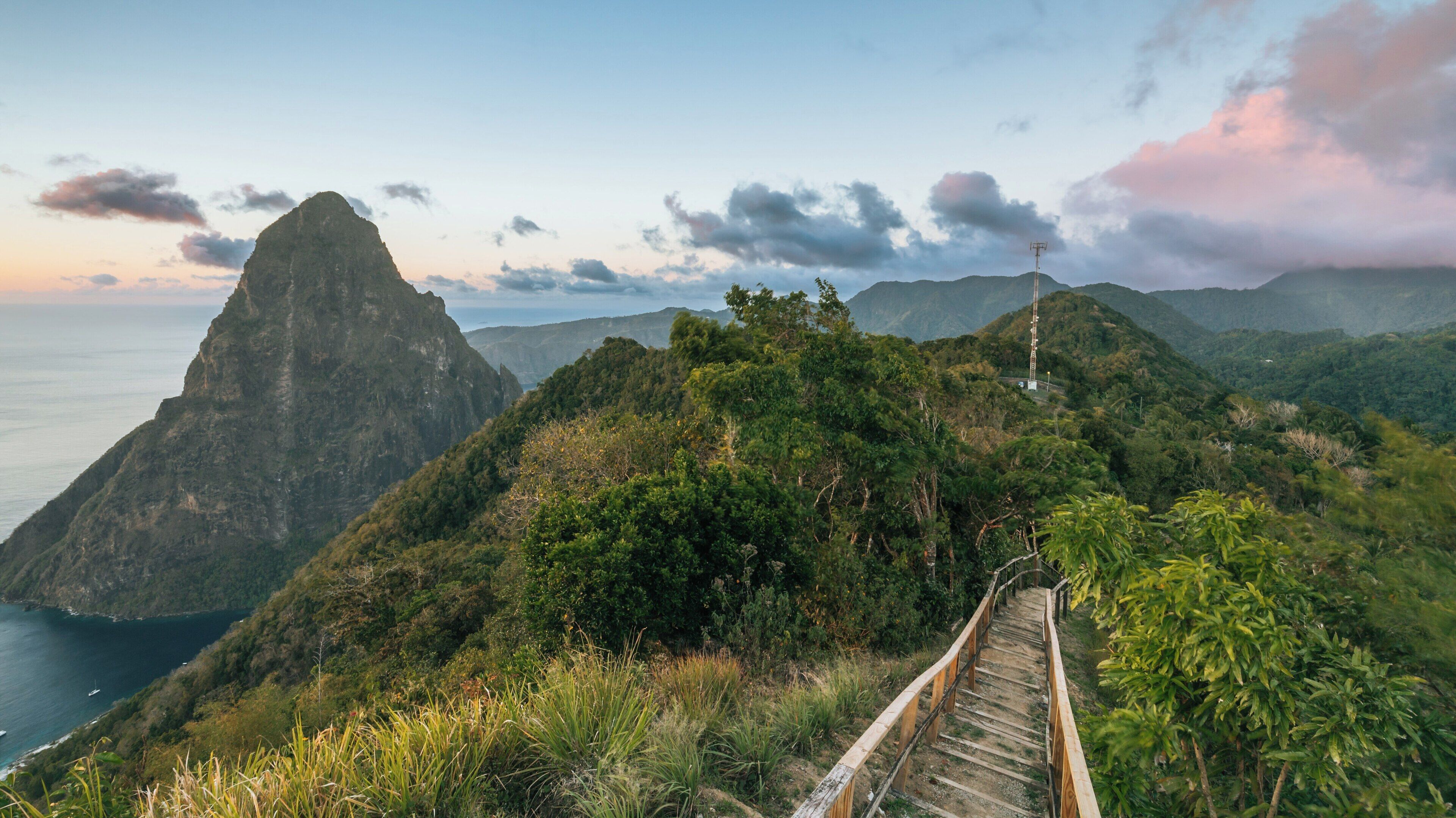 Explore the stunning Tet Paul Nature Trail in Soufrière, St. Lucia, with breathtaking views of the Pitons and lush landscapes during sunset