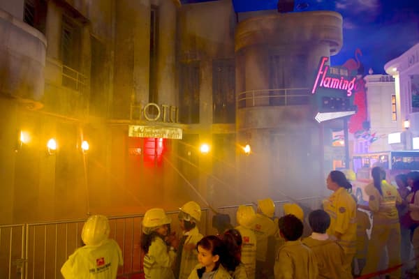 KidZania featuring a city and signage as well as a large group of people