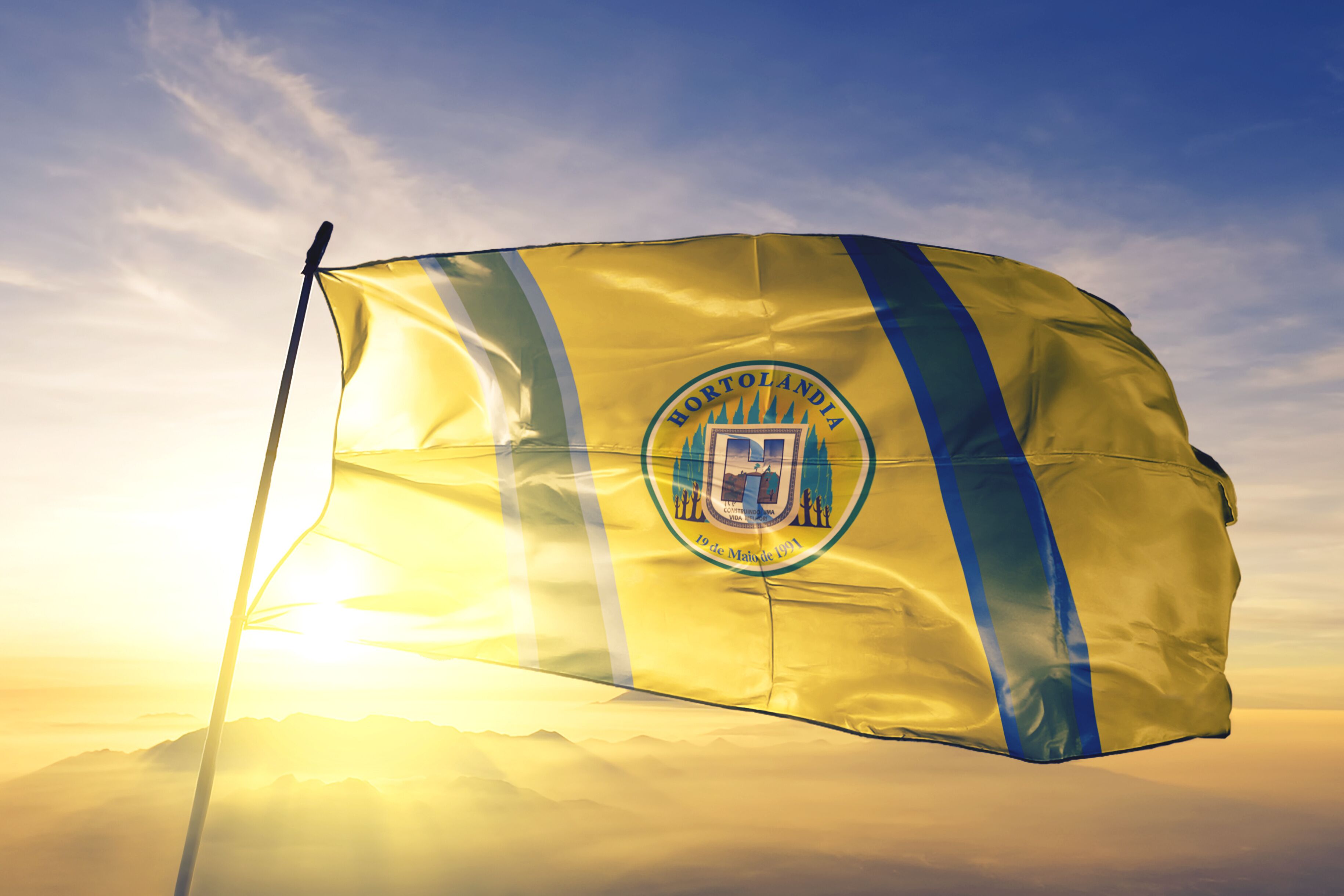 Hortolandia of Brazil flag waving on the top sunrise mist fog
