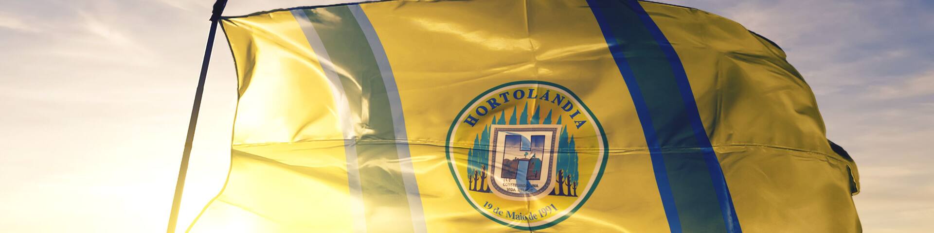 Hortolandia of Brazil flag waving on the top sunrise mist fog