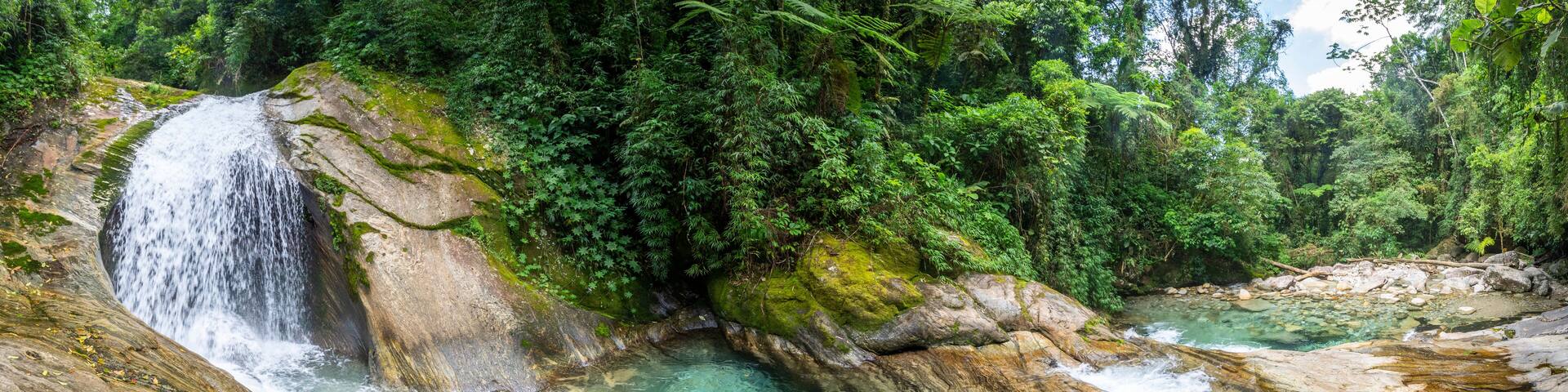 Beautiful view to green atlantic rainforest waterfall with blue water