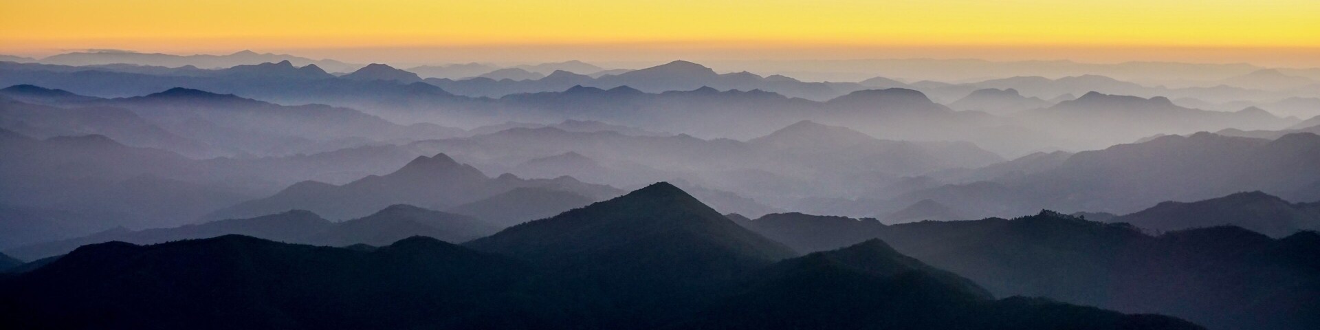 A mountain range with a sunrise or sunset.