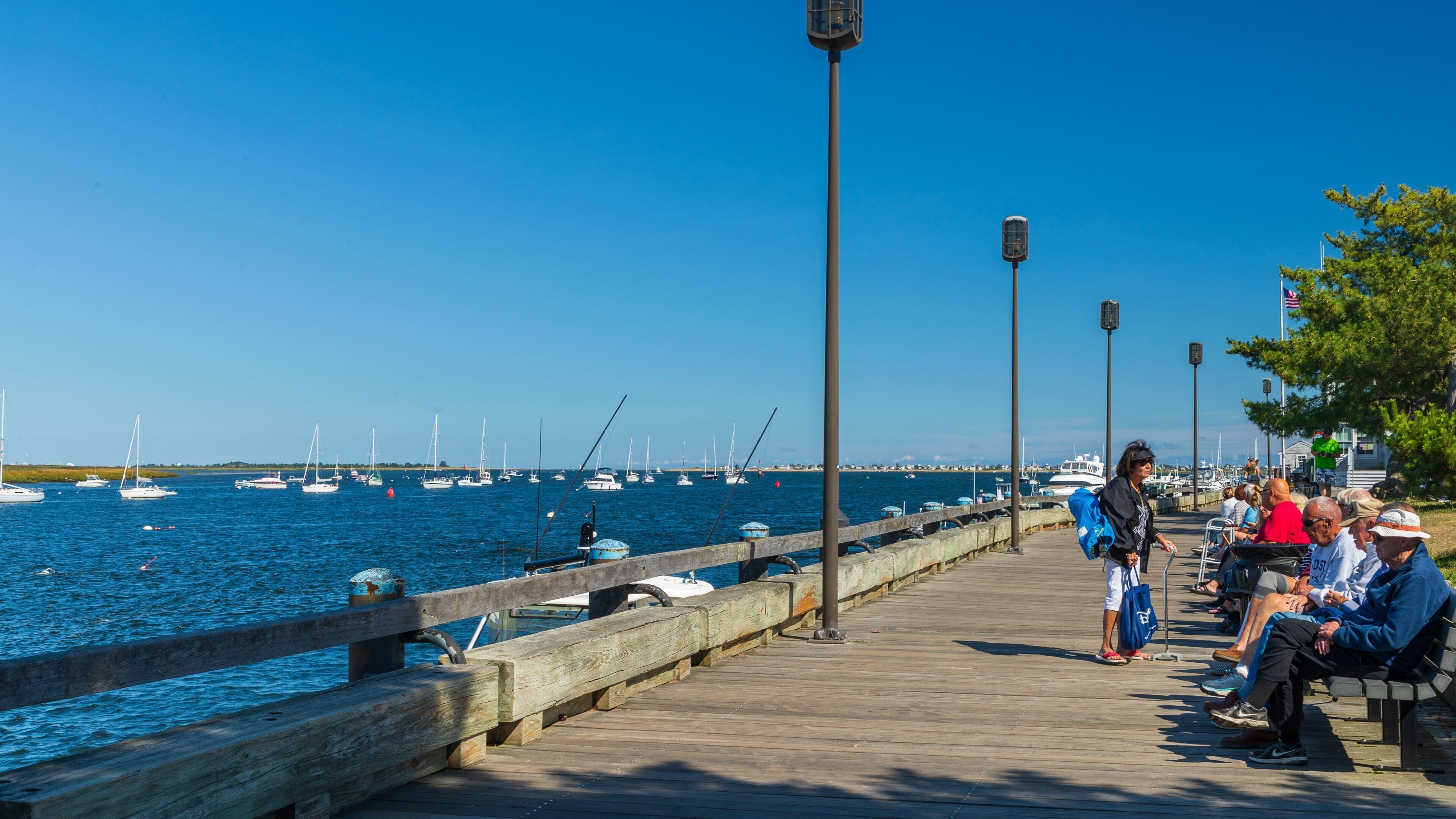 Waterfront Promenade Park which includes a bay or harbor as well as a small group of people