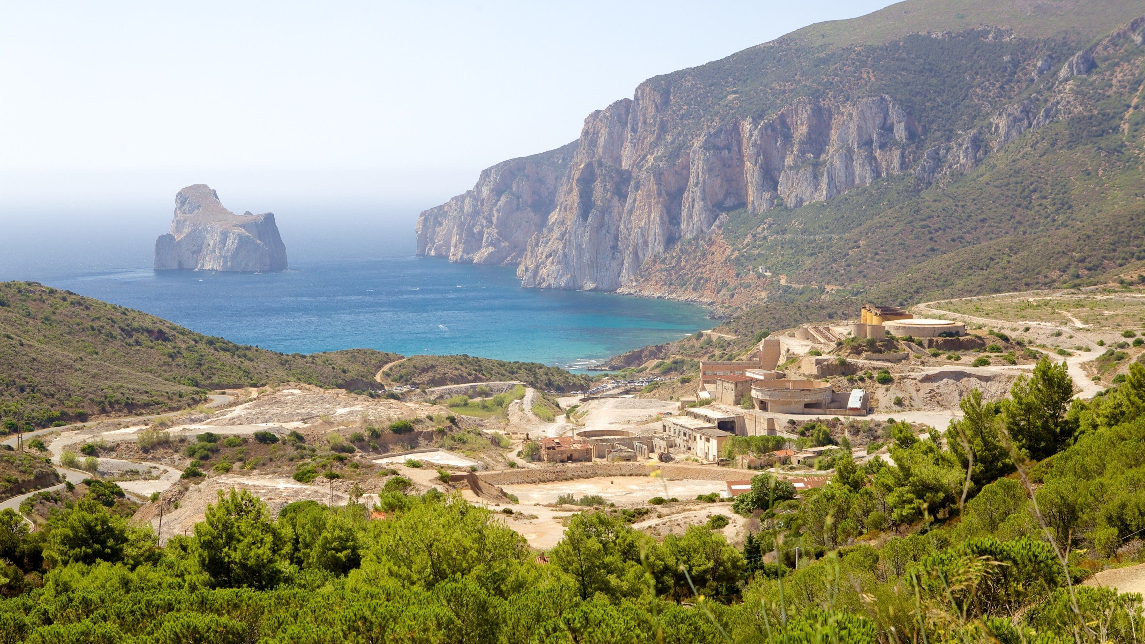 Porto Flavia featuring general coastal views