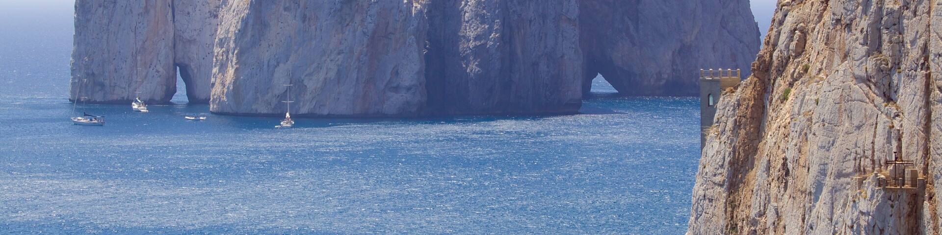 Porto Flavia which includes rugged coastline