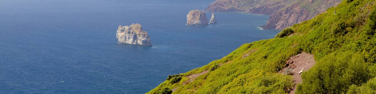 Porto Flavia which includes rugged coastline