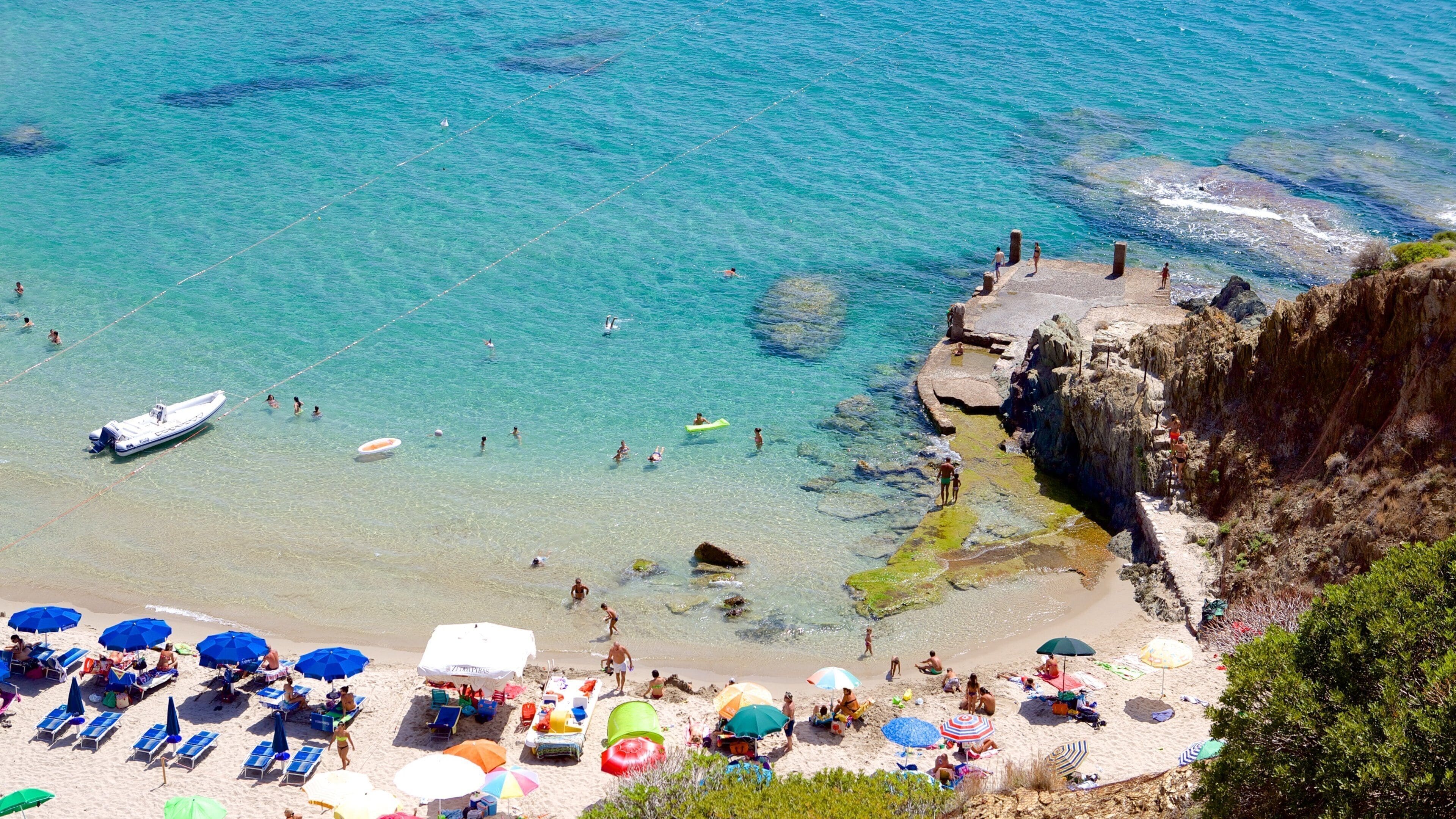 Porto Flavia showing swimming and a beach