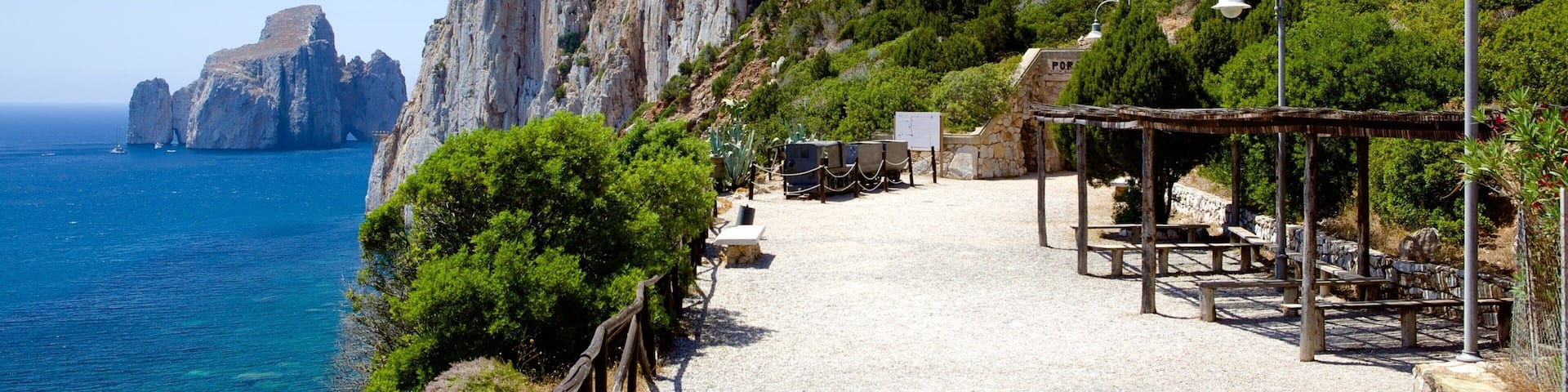 Porto Flavia featuring rocky coastline