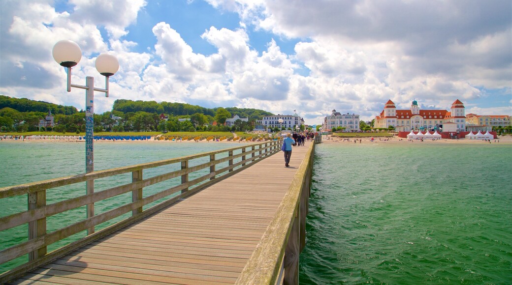 Binz Pier showing a coastal town and general coastal views as well as a small group of people