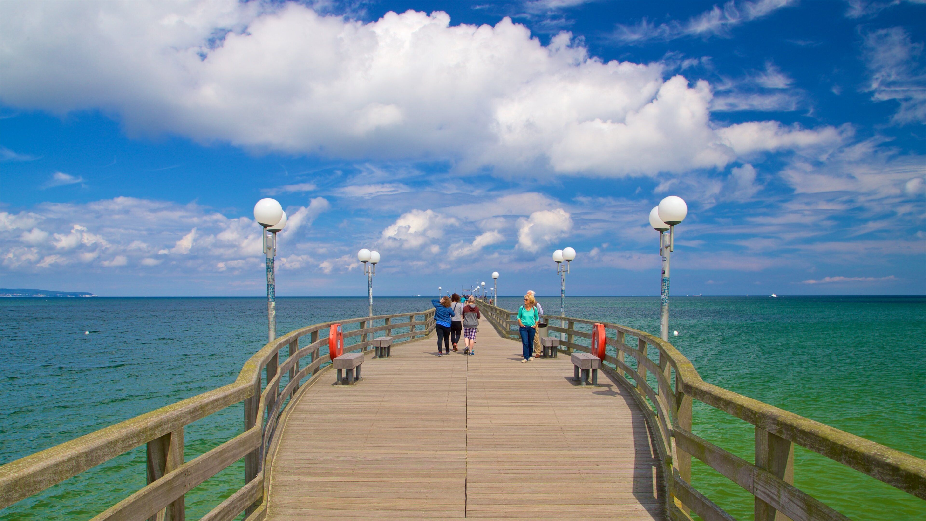 Binz Pier which includes general coastal views as well as a small group of people