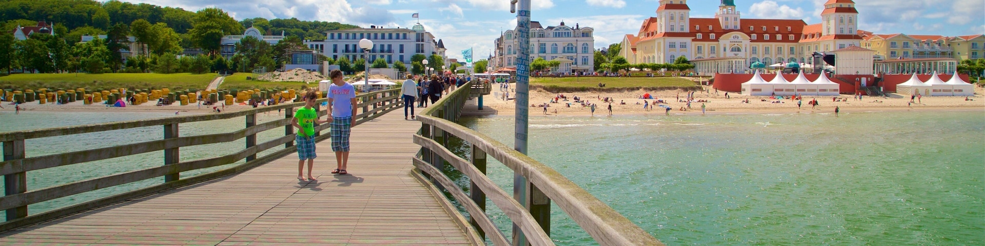 Binz Pier which includes general coastal views and a coastal town as well as a couple