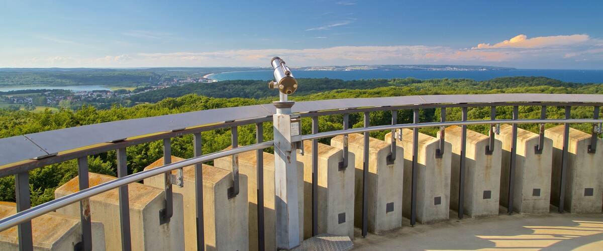 A panoramic view from a high vantage point overlooking a coastal landscape with a clear sky.