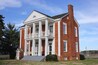 During the 1790s, James Vann became a Cherokee Indian leader and wealthy businessman. He established the largest and most prosperous plantation in the Cherokee Nation, covering 1,000 acres of what is now Murray County. In 1804 he completed construction of a beautiful 2 ½-story brick home that was the most elegant in the Cherokee Nation. After Vann was murdered in 1809, his son Joseph inherited the mansion and plantation. Joseph was also a Cherokee leader and became even more wealthy than his father.
In the 1830s almost the entire Cherokee Nation was forced west by state and federal troops on the infamous Trail of Tears. The Vann family lost their elegant home, rebuilding in the Cherokee Territory of Oklahoma. Today the Vann House survives as Georgia’s best-preserved historic Cherokee Indian home. A guided tour allows visitors to see the house which features beautiful hand carvings, a remarkable “floating” staircase, a 12-foot mantle and fine antiques.