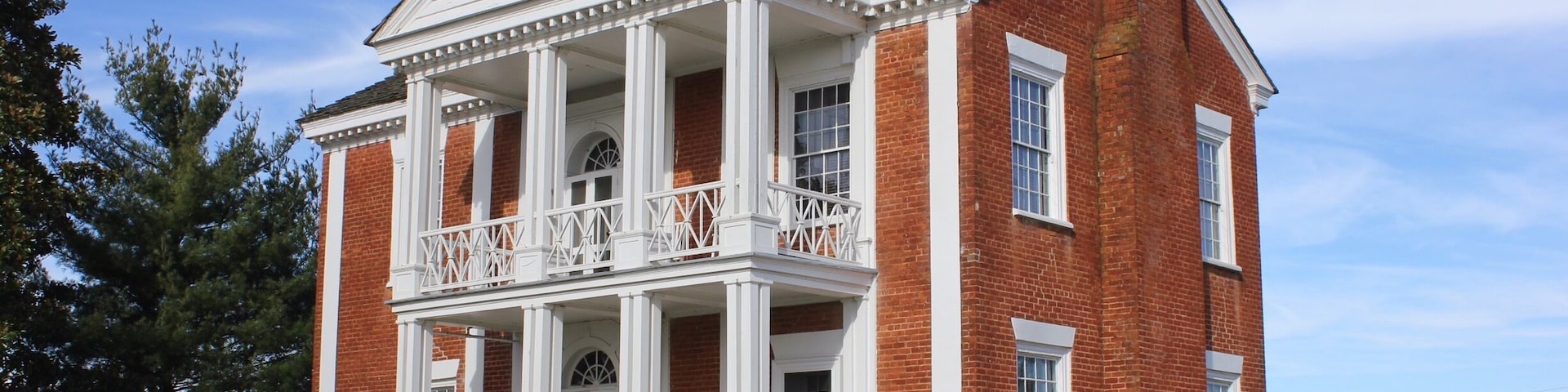 During the 1790s, James Vann became a Cherokee Indian leader and wealthy businessman. He established the largest and most prosperous plantation in the Cherokee Nation, covering 1,000 acres of what is now Murray County. In 1804 he completed construction of a beautiful 2 ½-story brick home that was the most elegant in the Cherokee Nation. After Vann was murdered in 1809, his son Joseph inherited the mansion and plantation. Joseph was also a Cherokee leader and became even more wealthy than his father.
In the 1830s almost the entire Cherokee Nation was forced west by state and federal troops on the infamous Trail of Tears. The Vann family lost their elegant home, rebuilding in the Cherokee Territory of Oklahoma. Today the Vann House survives as Georgia’s best-preserved historic Cherokee Indian home. A guided tour allows visitors to see the house which features beautiful hand carvings, a remarkable “floating” staircase, a 12-foot mantle and fine antiques.