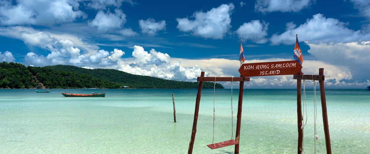 Original and stylish wooden swing standing in the water at the beach of Koh Rong Samloem tropical island. Saracen Bay, Cambodia.