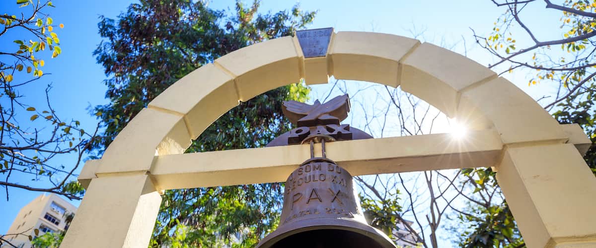A bell with inscriptions and an arch structure.