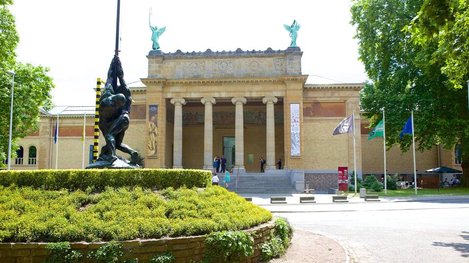 Citadel Park which includes a statue or sculpture, a garden and heritage architecture