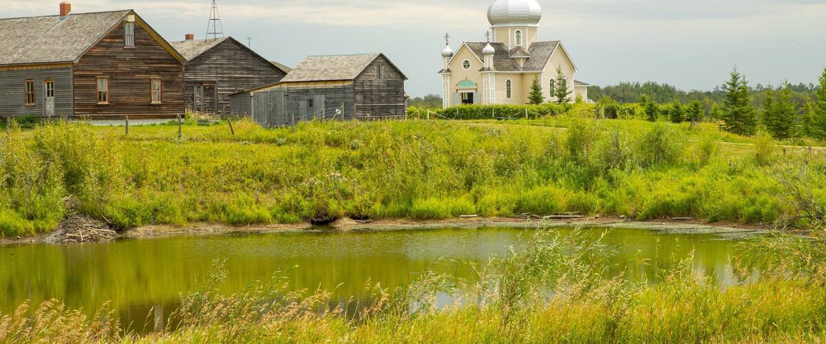 Ukrainian Cultural Heritage Village featuring a pond, a small town or village and a mosque