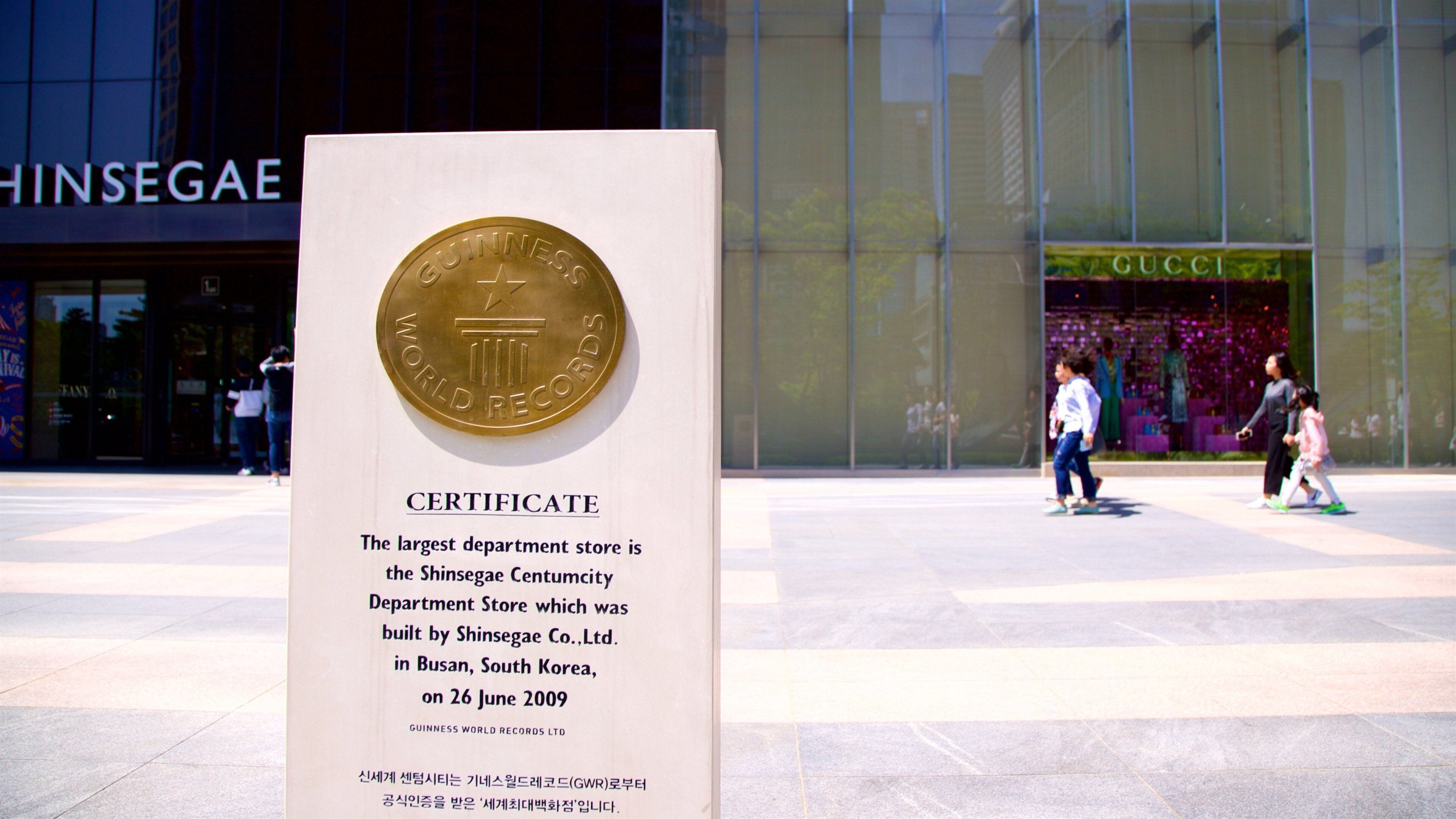 Shinsegae Centum City featuring signage as well as a family