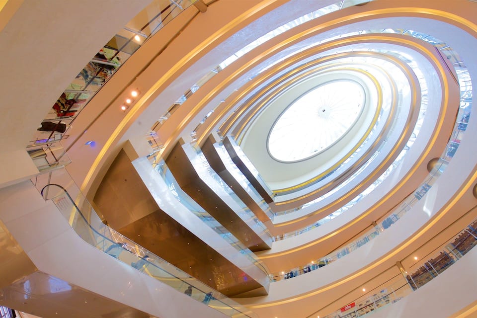 A multi-level shopping mall with a central atrium and multiple floors.