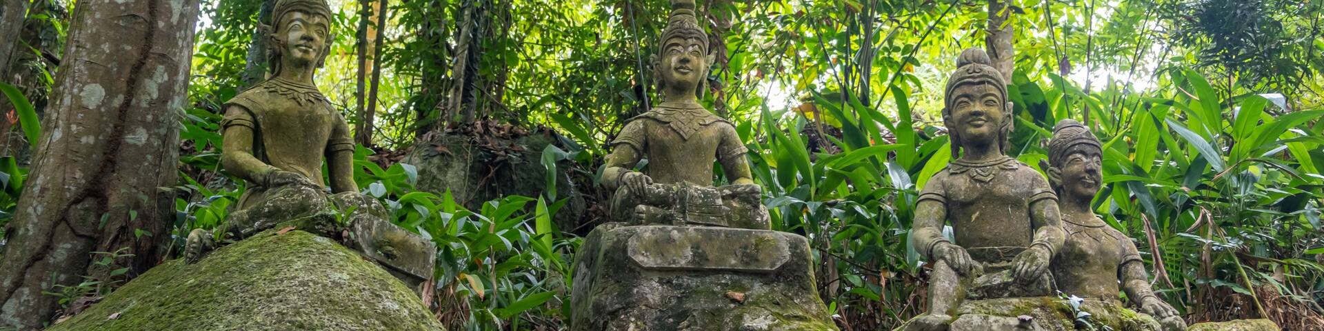 Ancient stone statues in Secret Buddhism Magic Garden, Koh Samui, Thailand. A place for relaxation and meditation. Secret Buddha Garden